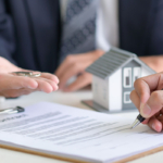 Home buyer signs the mortgage papers