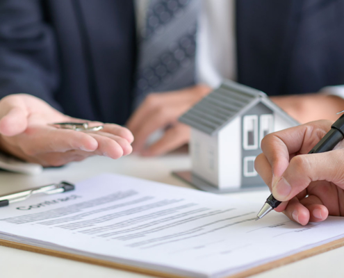 Home buyer signs the mortgage papers